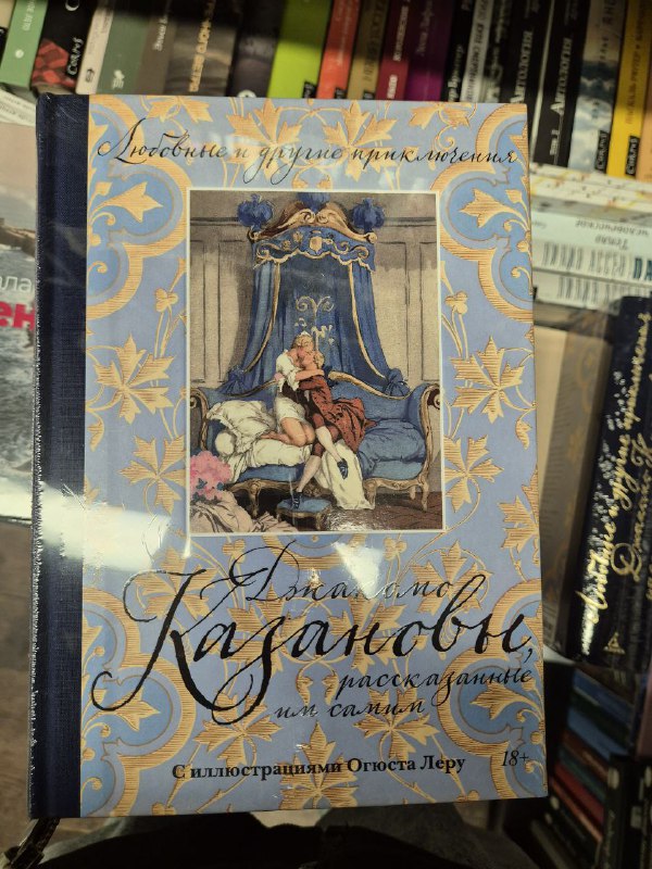 Богато иллюстрированное издание Казановы с декоративной обложкой, лежащее на стопке книг в магазине и показывающее художественный форзац.