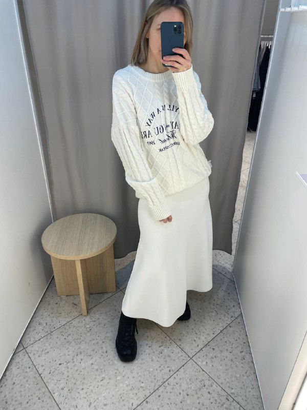 Фото в примерочной: сочетание белой юбки и светлого свитера, показывает вариант носки юбки с более повседневным верхом и длину изделия на модели.