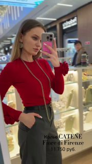 Женщина делает селфи у витрины магазина Rosone, на ней несколько золотых цепочек Fiore di Firenze разной длины и фактуры.