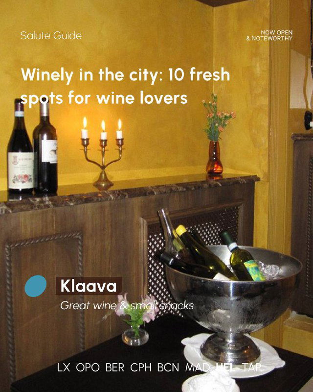 Wine bottles chilled in a metal bucket on a marble surface with warm decorative lighting, an intimate corner of a wine-focused venue.