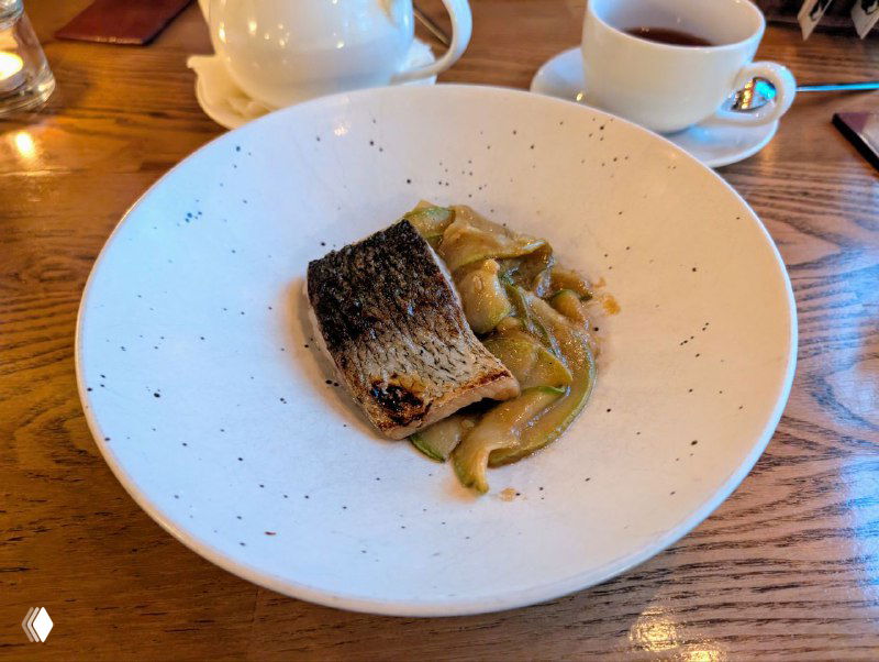 Запечённая пелядь на белой тарелке с гарниром — минималистичная подача традиционной северной рыбы в авторском варианте.