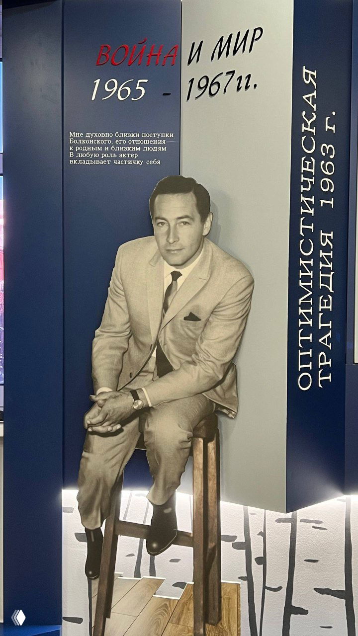 Большой стенд «Война и мир» с фотографией молодого Тихонова в костюме и текстовой панелью, объясняющей роль Болконского и контекст съёмок в 1960‑е годы.