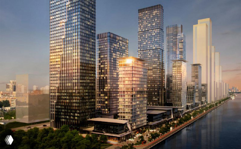 Рендер проектируемого комплекса: несколько высоких стеклянных башен вдоль набережной, вечернее освещение и пешеходная набережная.