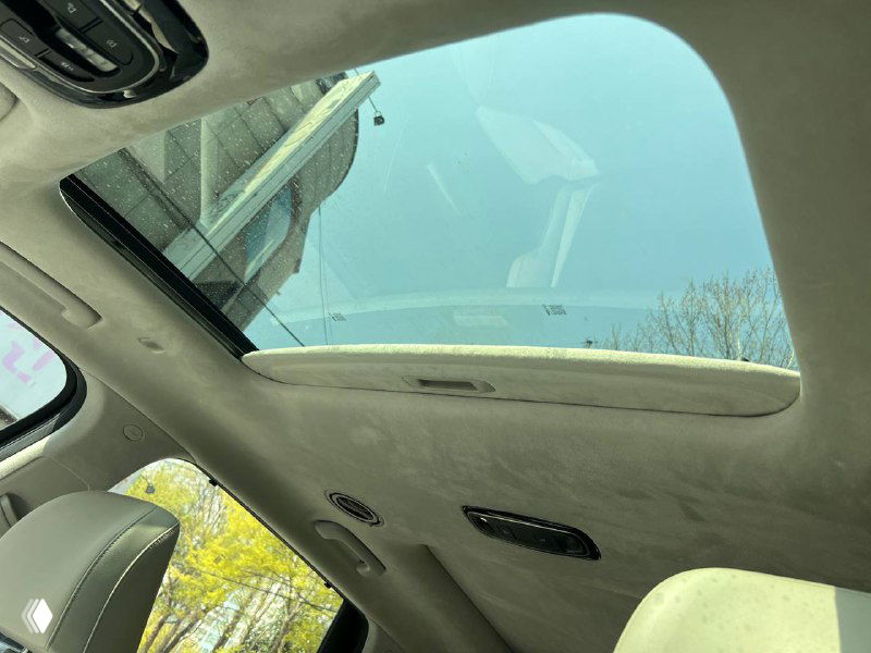 Люк в крыше (панорамный) Hyundai Palisade Prestige, вид из салона вверх на стеклянную секцию и обшивку потолка вокруг люка.