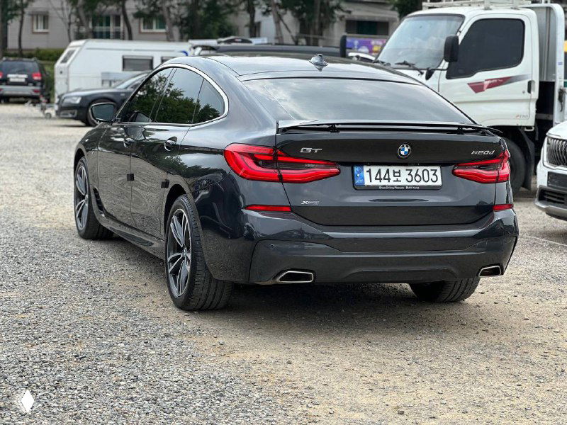 Диагональный ракурс задней части BMW GT 620D, демонстрация силуэта кузова, дисков и общего состояния лакокрасочного покрытия на автомобиле.