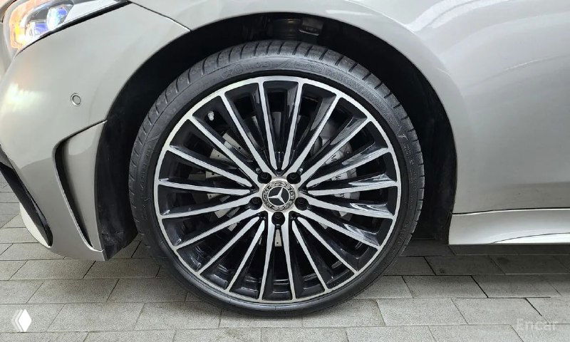 Крупный план легкосплавного колёсного диска Mercedes‑Benz CLS450 с узнаваемым центром и дизайном шпица, состояние колеса видно детально.