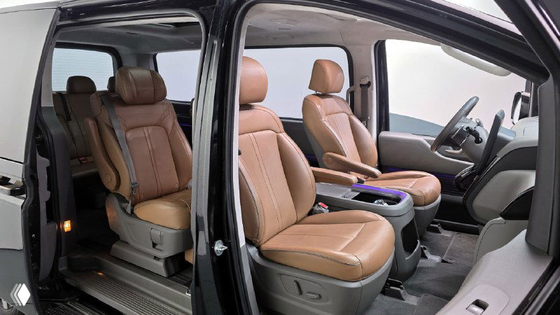 Второй ряд сидений Hyundai Staria: роскошные бежевые кожаные кресла с подлокотниками, простор для пассажиров и удобная центральная зона прохода.
