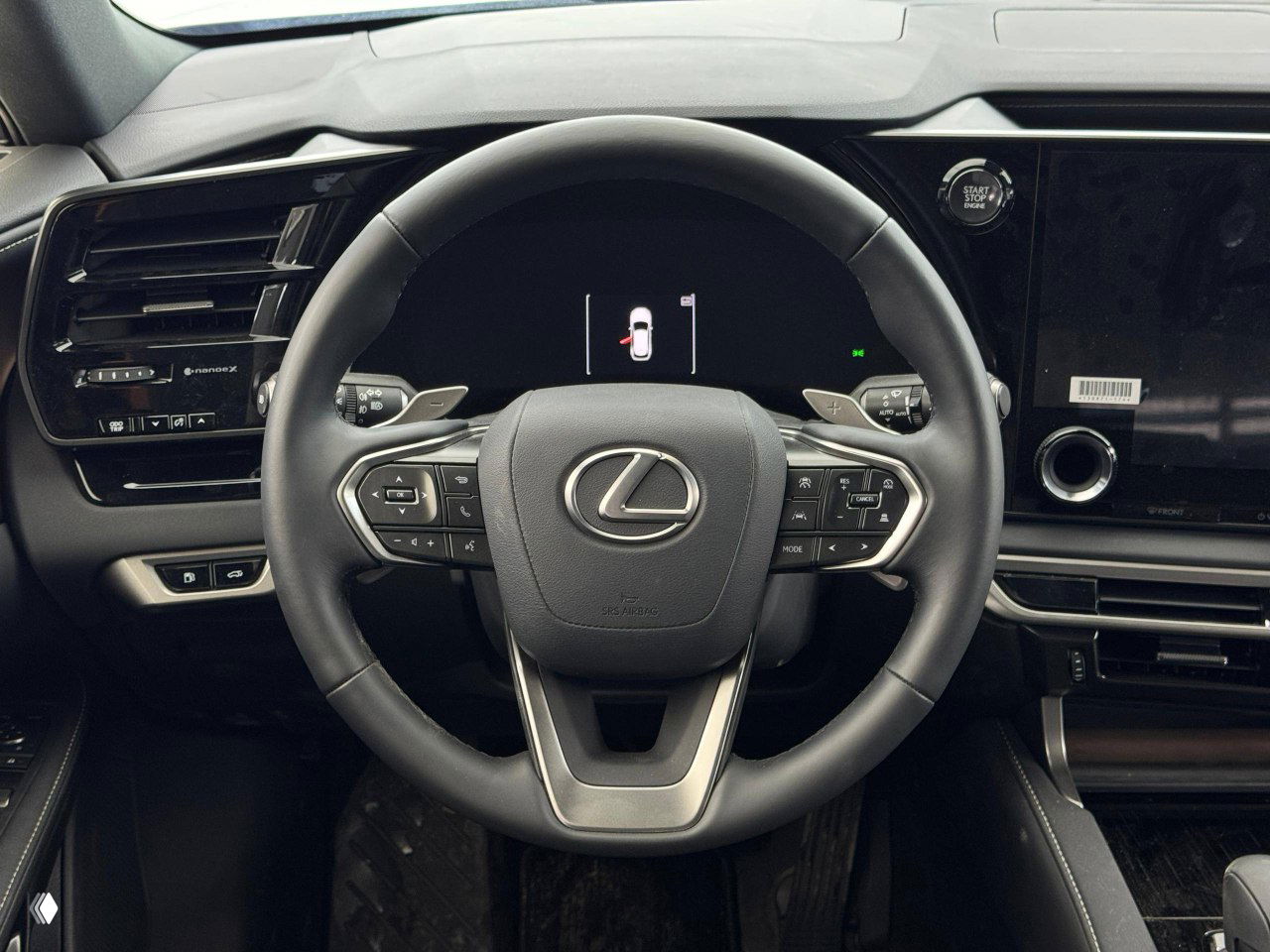 Вид интерьера с рулём и пассажирской стороны Lexus RX 300 2026, видна отделка торпеды, экран и элементы управления климатом и мультимедиа.