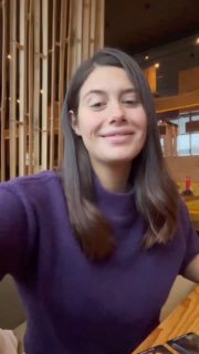 Портрет женщины-автора/ведущей в интерьере: улыбается в кадре вертикального формата, даёт живой контекст к разбору и видеообращению.