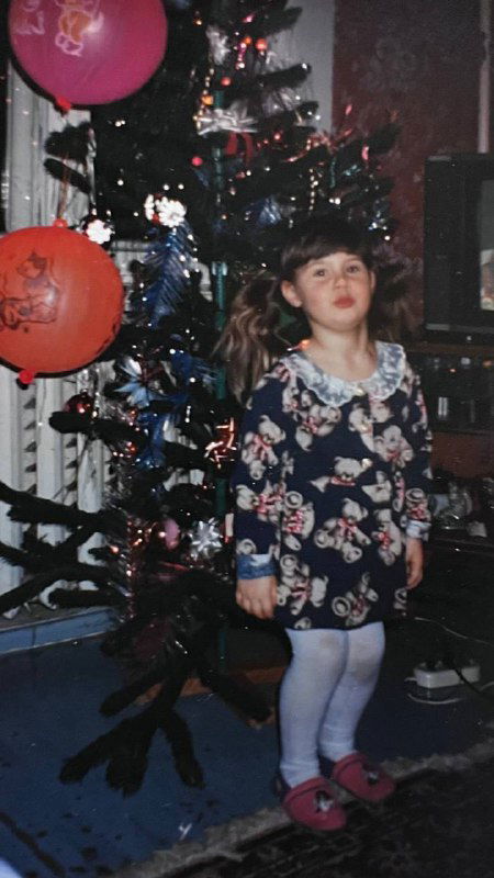 Девочка в праздничном платье у новогодней елки в квартире 90‑х — праздничная сцена и детские традиции в Коломне.