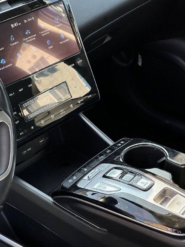 Центральный тоннель и область селектора передач Hyundai Tucson: подстаканники, кнопки управления и отделка салона — крупный план для оценки комплектации и состояния.