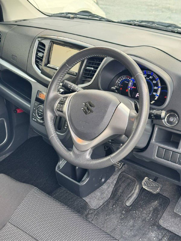 Водительская зона салона Suzuki Wagon R: руль, панель приборов и центральная консоль — общий вид приборной панели и рулевого колеса.