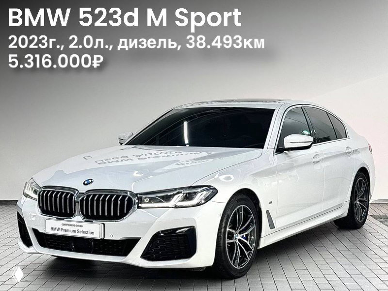 Белый BMW 523d M Sport 2023 года в профиль на студийном фоне: видны колёсные диски, боковая линия и рекламная визка цены 5.316.000₽.