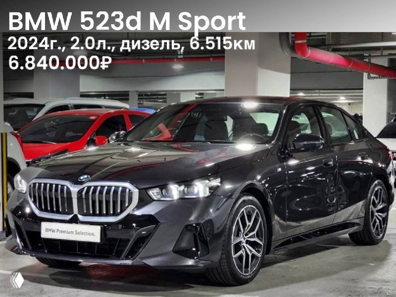 Фотография BMW 523d M Sport (тёмный цвет) 2024 года — вид спереди в подземном паркинге, указаны год, объём двигателя, пробег и цена на изображении.