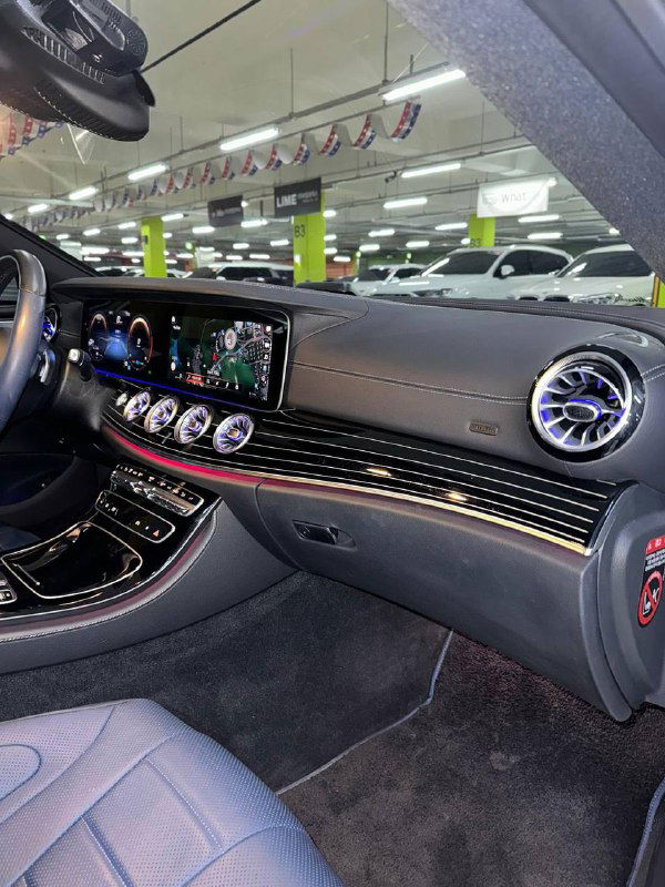 Торпедо и декоративная панель Mercedes‑Benz CLS450 с подсветкой, воздуховодами и качественной отделкой — общий вид передней части салона и декоративных элементов.