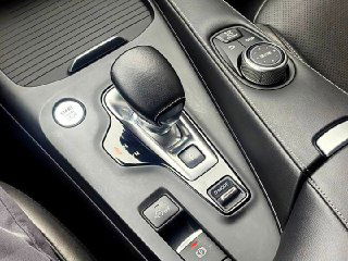 Крупный план центральной консоли и селектора вариатора Infiniti QX50, видны кнопки управления, отделка и подстаканник, состояние салона.
