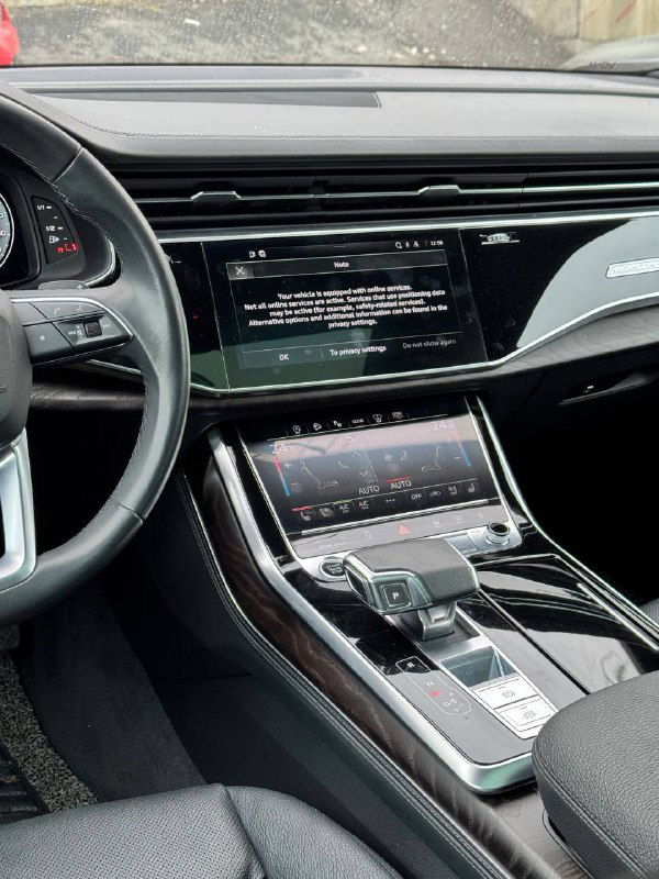 Центральная консоль Audi Q8 с мультимедийным экраном и сенсорной панелью управления климатом и настройками салона.