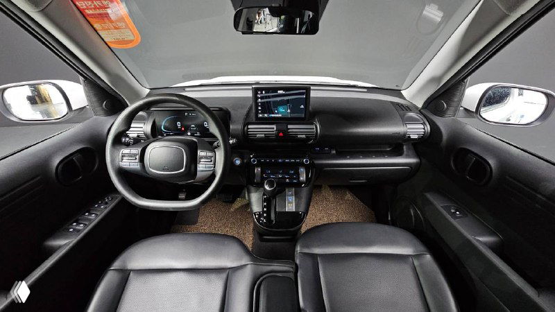 Салон Hyundai Casper: вид спереди на приборную панель, мультимедиа-экран, руль и передние сиденья в интерьерной модификации.