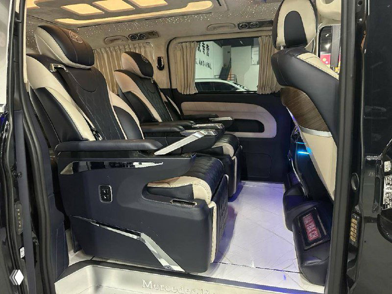 Вид на трансформируемый салон Mercedes Vito с капитанскими креслами, отделка премиум-класса и посадочные места для пассажиров второго ряда.