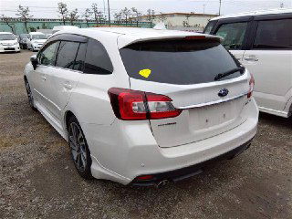 Задний ракурс белого Subaru Levorg 2017 на стоянке ярда: багажник, задние фары и кузов, номер отсутствует, другие машины вокруг.