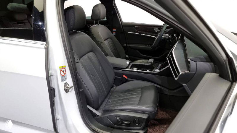 Переднее пассажирское сиденье Audi A6 со стороны дверного проема; видна обивка сиденья, регулировки и состояние порога, демонстрирующие аккуратную сохранность интерьера