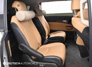 Второй ряд сидений KIA Carnival 2020 — вид на девятиместный салон, два отдельных кресла с подголовниками и пространство между ними.