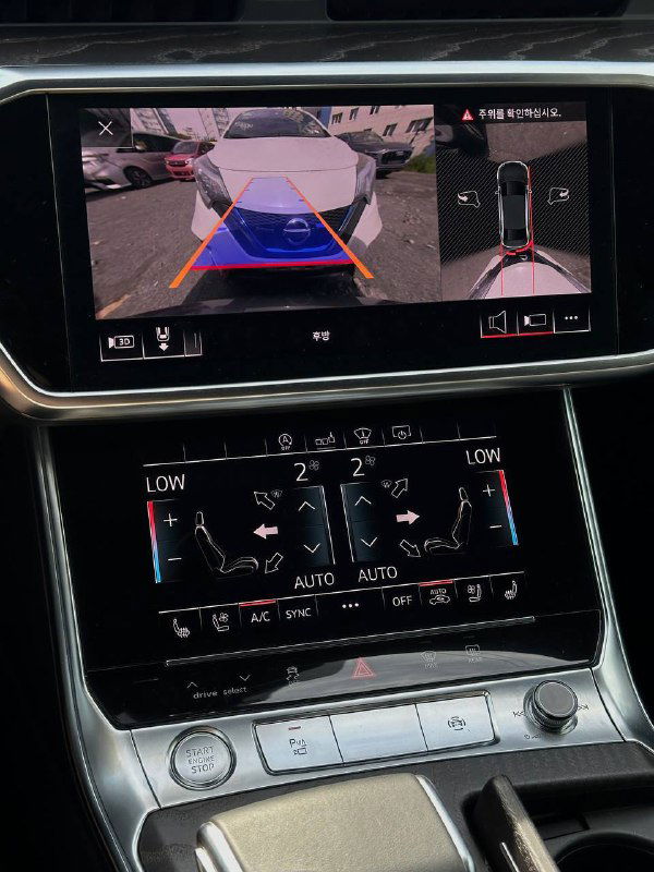 Центральная консоль Audi A6 с экраном камеры заднего вида и сенсорным блоком управления климатом и мультимедиа.