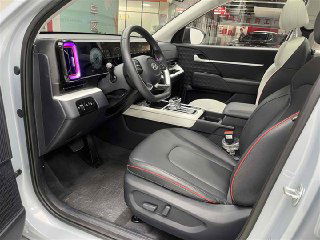 Вид на водительское и пассажирское сиденья Hyundai Mufasa: комбинированная обивка, регулировки сидений и общая эргономика переднего ряда.