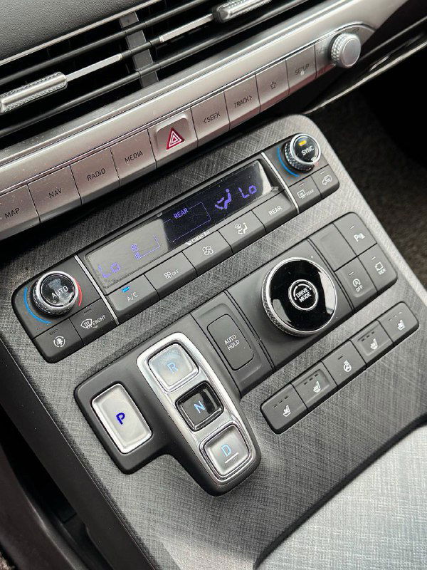 Блок управления климат-контролем и клавиши переключения на центральной консоли Hyundai Palisade крупным планом, видна отделка и эргономика.