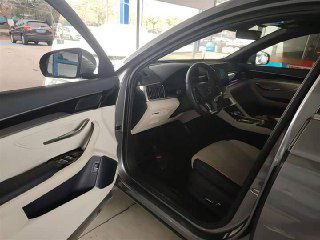 Открытая дверь водителя и вид на передний ряд: пространство для ног, карта дверной панели и комбинация материалов интерьера в Song Plus New.