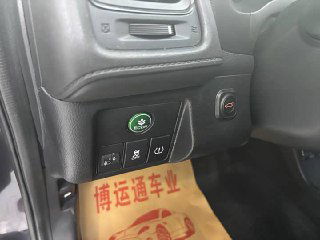 Блок кнопок слева от руля Honda Vezel 2022: кнопки ECO и другие органы управления, видна часть коврика с китайской печатью автосервиса.