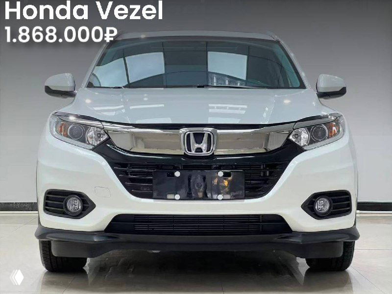 Белый Honda Vezel 2022 года, фронтальный вид в салоне, указаны пробег 7.600 км и цена 1.868.000₽ на фото.