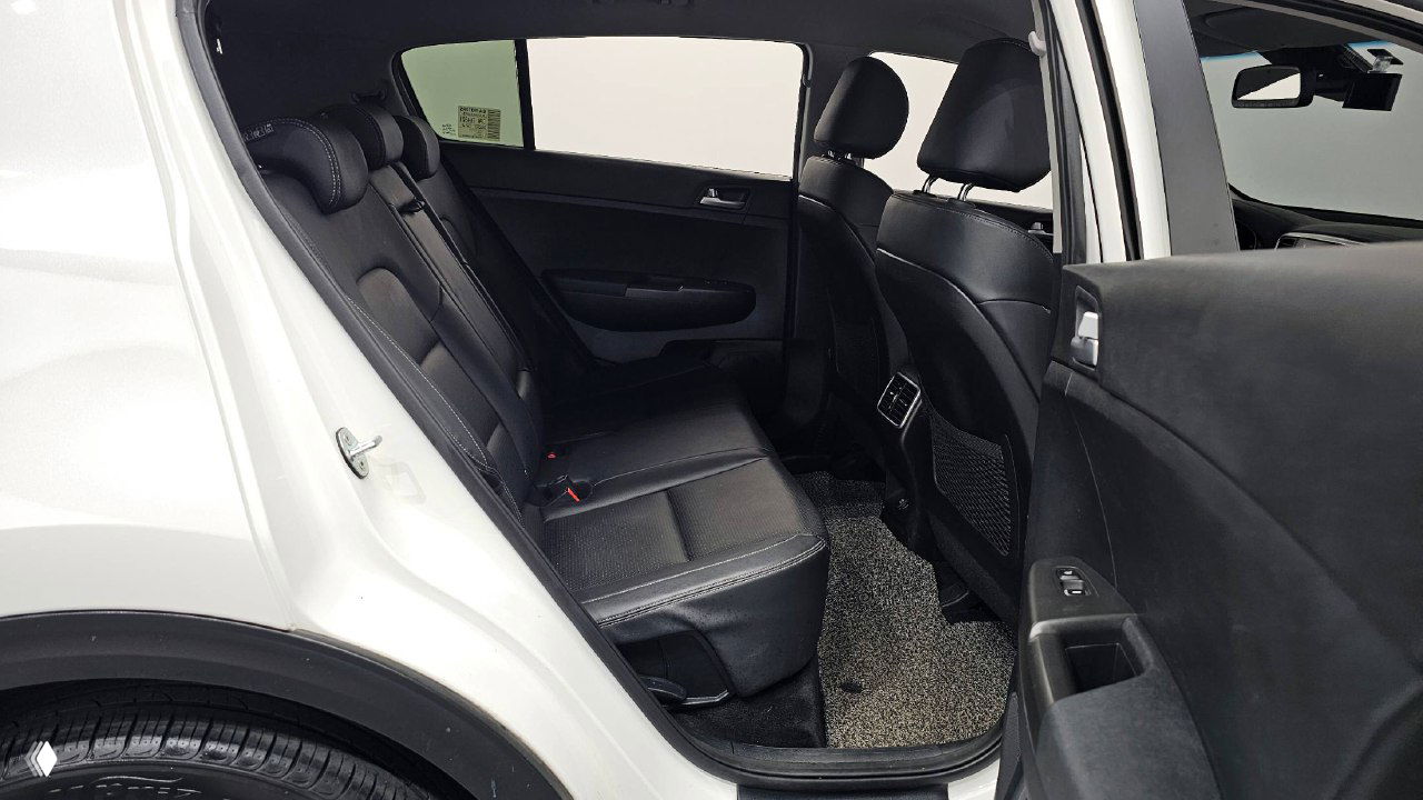 Задний ряд сидений KIA Sportage: чёрная кожаная обивка, пространство для пассажиров и задние подголовники — фото для оценки места на заднем сиденье.