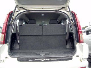Открытый багажник Honda Crossroad с поднятыми задними сиденьями, виден объём и состояние ковролина в грузовом отсеке.