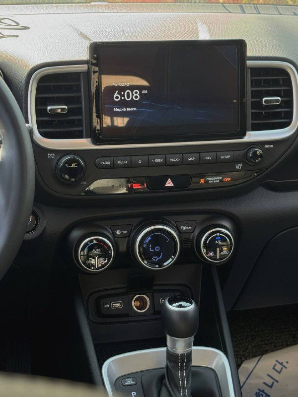 Центральная консоль и мультимедийный экран Hyundai Venue, отображение часов и элементов управления на торпедо автомобиля.