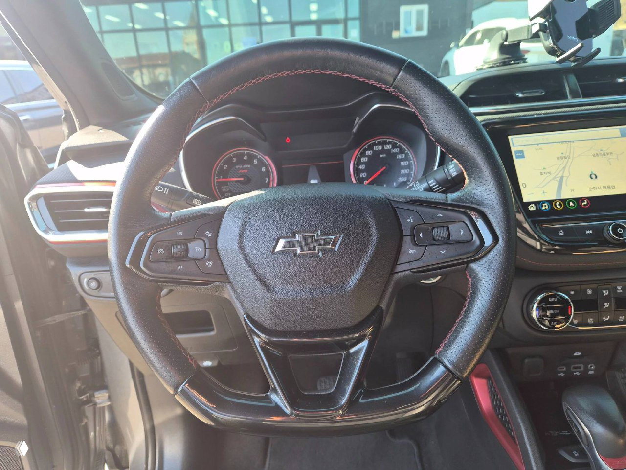 Интерьер: рулевое колесо Chevrolet с эмблемой, приборная панель и мультимедиа экран, общий вид водительской зоны с акцентом на состояние салона.