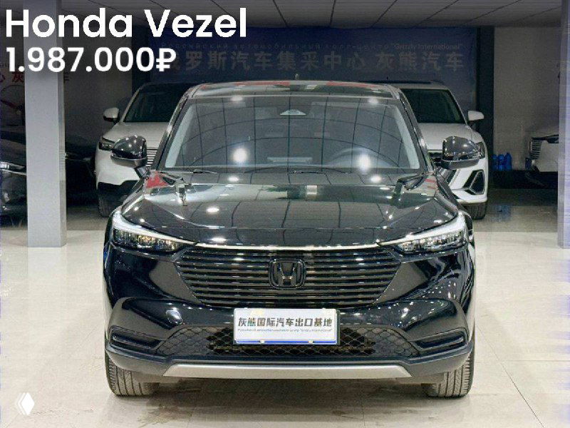 Чёрный Honda Vezel в выставочном зале, фронтальный вид, отражение потолочного света и указание цены 1.987.000₽ на фото.