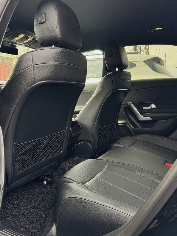 Задний ряд сидений Mercedes A200d: состояние обшивки и пространства для ног, показывает практичность салона для пассажиров.