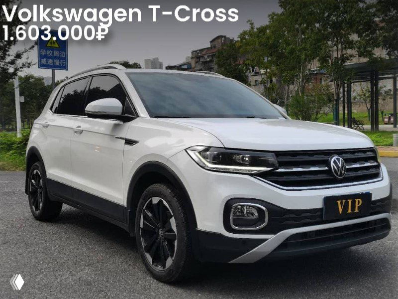 Фронтальная фотография белого Volkswagen T‑Cross на улице/парковке; видны боковые зеркала, диски и цена 1.603.000₽ на изображении.