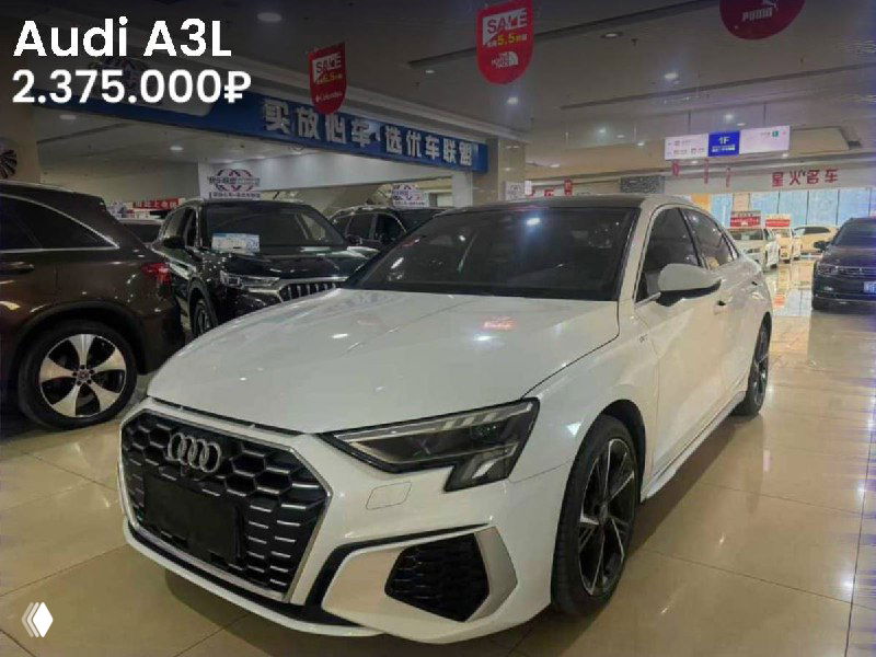 Фото белого Audi A3L в салоне, вид спереди-углом; указаны пробег 16.000 км и цена 2.375.000₽, без окрасов.
