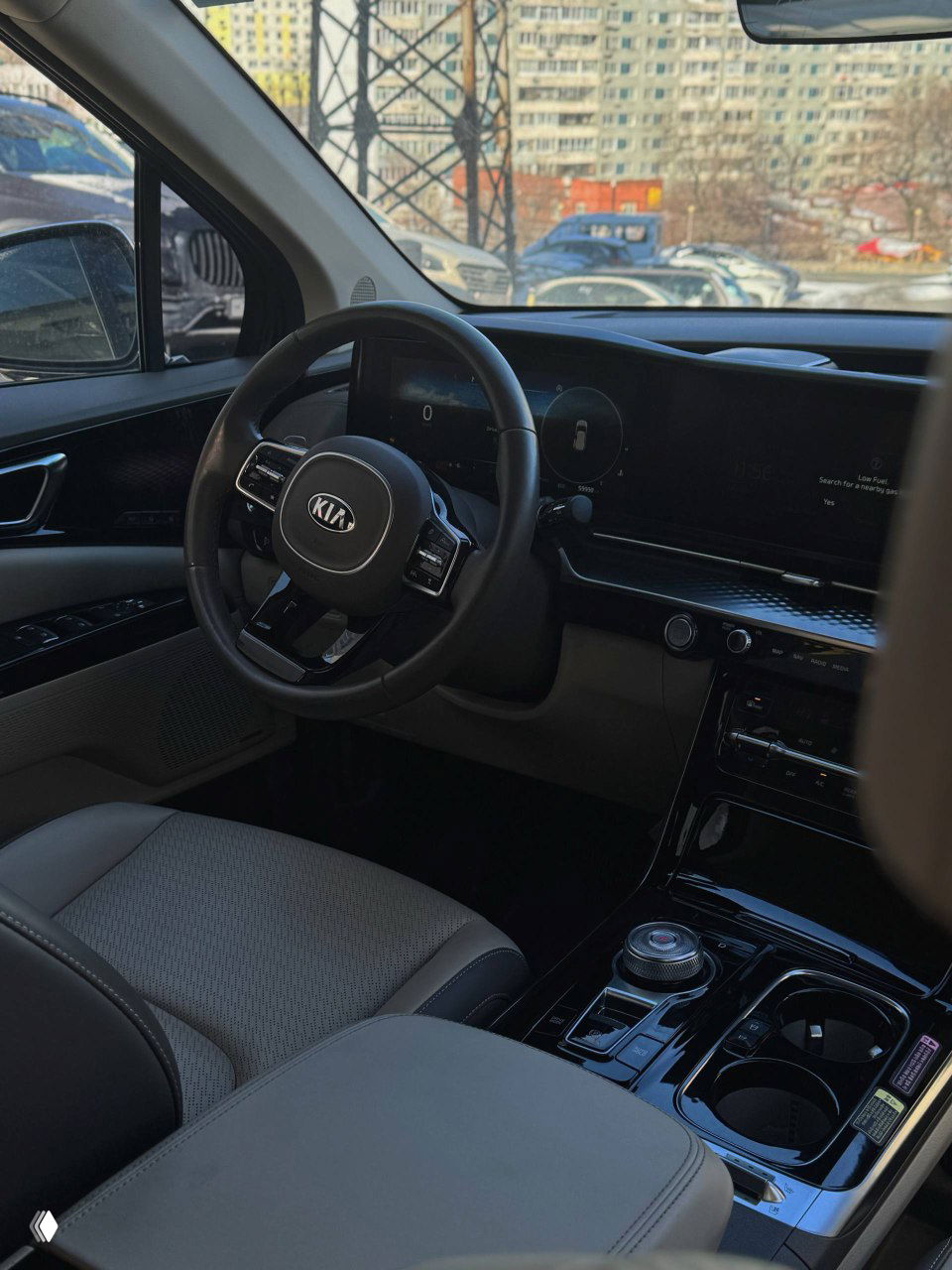 Передняя часть салона KIA Carnival — вид водителя, мультимедийный экран и торпедо, комбинация материалов и эргономика переднего ряда.