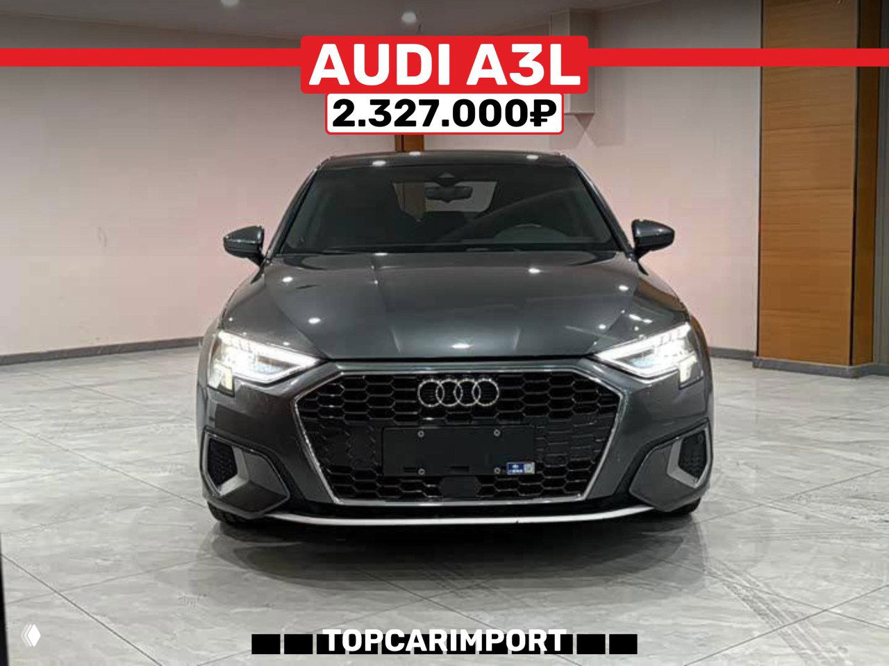 Фронтальный снимок Audi A3L 2021 в салоне, темно‑серый кузов, баннер с ценой 2.327.000₽ и подпись TOPCARIMPORT внизу.