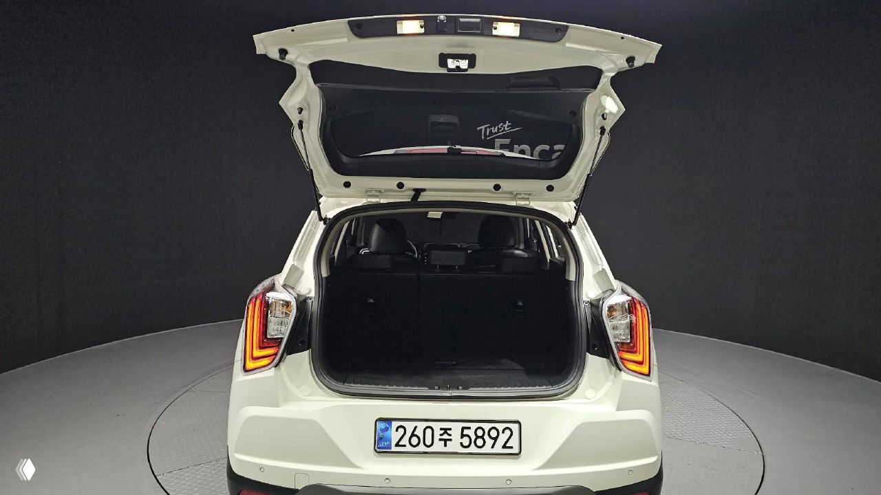 Открытый багажник SsangYong Tivoli — вид сзади в студии, пустой багажный отсек, задняя крышка поднята для демонстрации объёма.