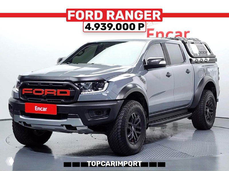 Серый Ford Ranger Raptor с дополнительным кунгом, стоящий в шоуруме; на верхнем баннере указана цена 4.939.000 ₽ и бренд продавца.