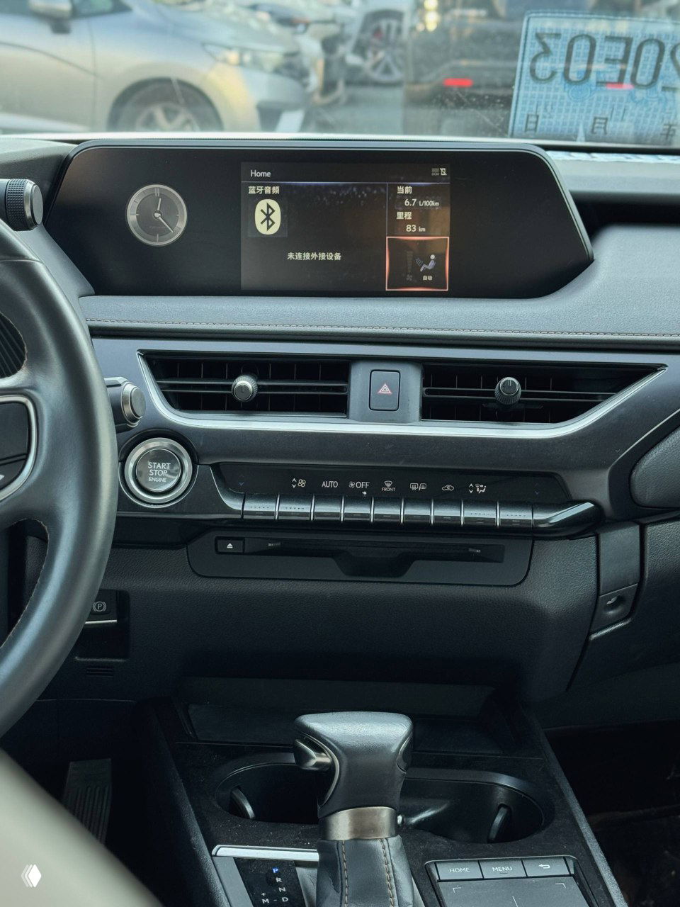 Панель приборов и центральный дисплей Lexus UX200; на экране интерфейс на китайском, видна кнопка Start/Stop и элементы управления климатом.