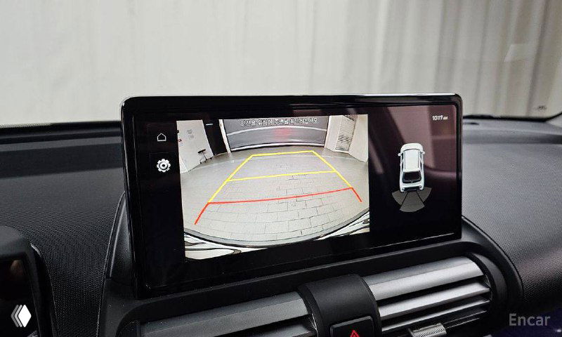 Экран мультимедиа Hyundai Casper показывает изображение с камеры заднего вида, рассчитанное для помощи при парковке в демонстрационном помещении.