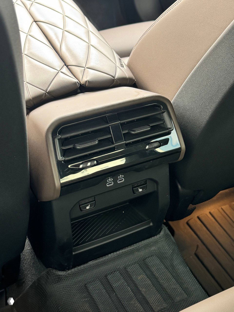 Крупный план задней панели с воздуховодами и USB-портами для пассажиров BMW, видны регулировки подогрева и отделка кожей.