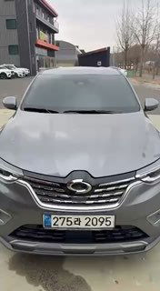 Фронтальный кадр серебристого кроссовера Samsung XM3 на стоянке в Южной Корее: видны решётка, фары и номерной знак.