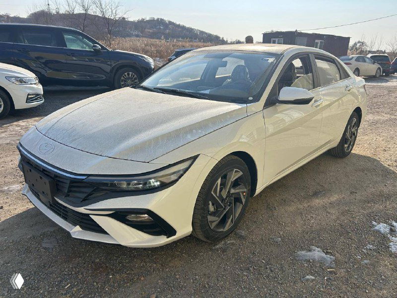 Белый Hyundai Elantra (новая) на стоянке в Уссурийске, вид спереди слева, чистый кузов и дневное освещение, готовится к отправке