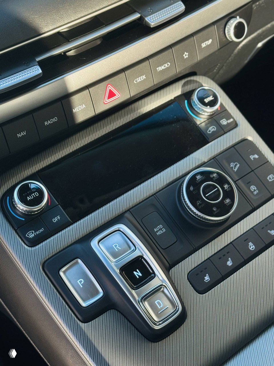 Крупный план центрального тоннеля с кнопками селектора передач P, R, N, D и органами управления климатом Hyundai Palisade